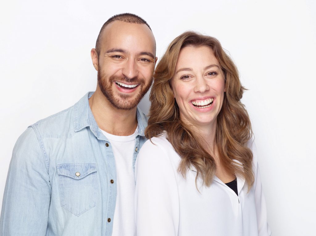 A man and woman showing off their straight teeth