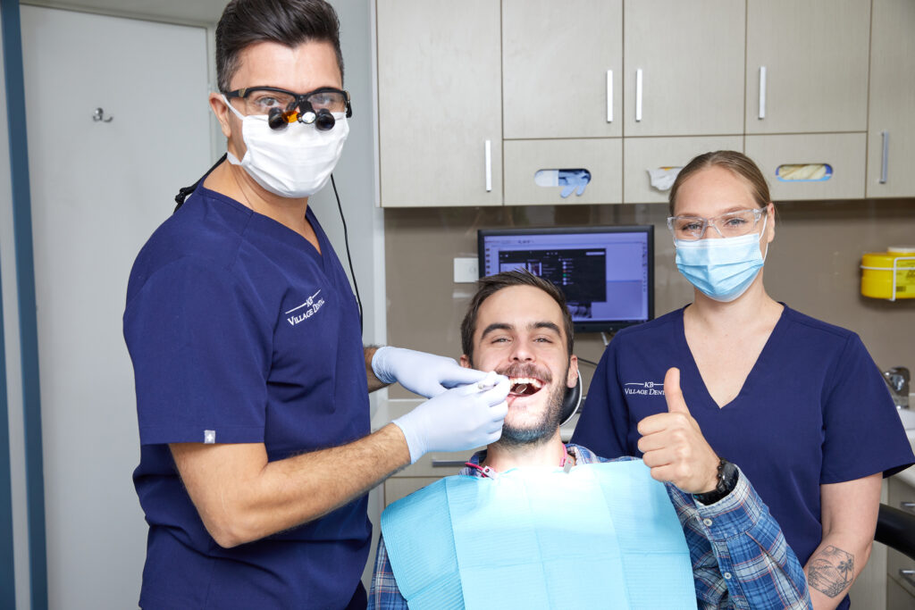 Two dentists and a happy patient