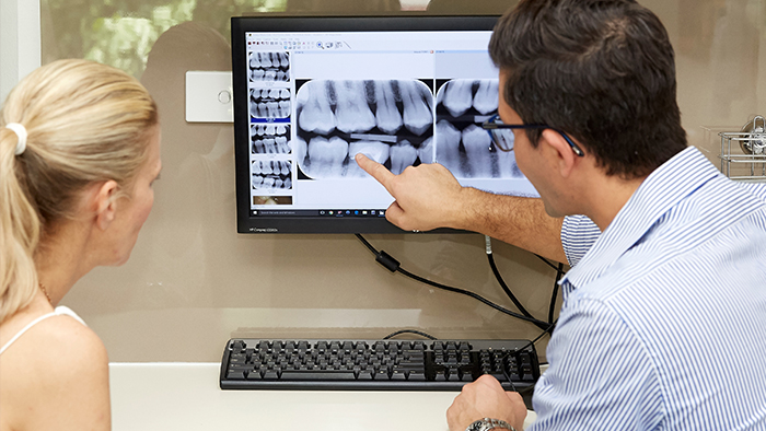 Sydney north shore dentist explaining dental crowns to woman