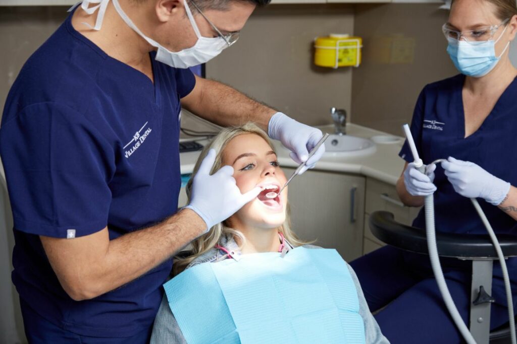 Young woman getting her teeth examined