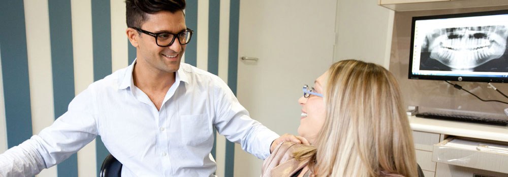 Dentist explaining cavities to patient