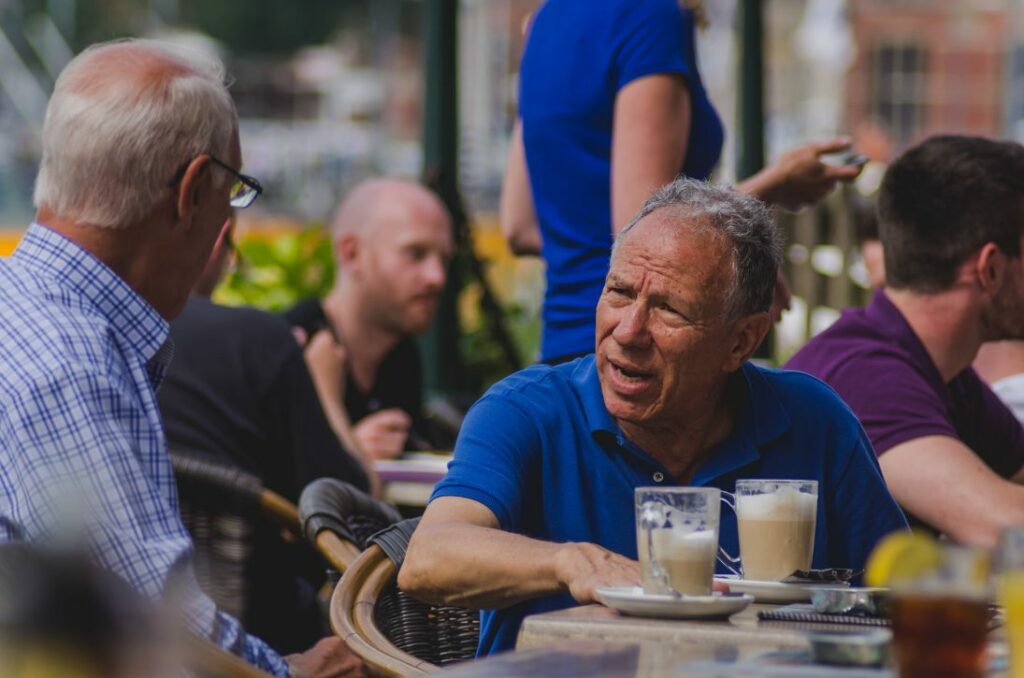 Two men talking at cafe